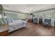 Bright bedroom with hardwood floors, ceiling fan, and plenty of natural light at 2149 Hontoon Rd, Deland, FL 32720