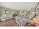 Charming bedroom featuring a decorative bed, desk, and ample natural light at 2149 Hontoon Rd, Deland, FL 32720