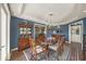 Formal dining room featuring a coffered ceiling, wood floors, and vintage furnishings with blue accents at 2149 Hontoon Rd, Deland, FL 32720