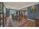 Elegant dining room showcasing blue walls, wood flooring, and French doors leading to a pool area at 2149 Hontoon Rd, Deland, FL 32720