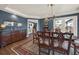 Elegant dining room featuring hardwood floors, blue walls, vintage furniture and a chandelier at 2149 Hontoon Rd, Deland, FL 32720