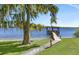 Picturesque waterfront property featuring a private wooden dock with gazebo leading to calm, open water at 2149 Hontoon Rd, Deland, FL 32720