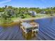 Magnificent aerial view of a private boat dock on the river, featuring a covered seating area and water access at 2149 Hontoon Rd, Deland, FL 32720