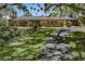 A single story home with a long driveway and manicured lawn at 2149 Hontoon Rd, Deland, FL 32720