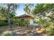 Exterior shot showcasing landscaping around the home with lush, mature trees at 2149 Hontoon Rd, Deland, FL 32720