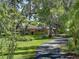 A single story home behind a long driveway lined with mature trees at 2149 Hontoon Rd, Deland, FL 32720