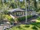 Exterior shot of a well-maintained home with black shutters and verdant lawn at 2149 Hontoon Rd, Deland, FL 32720