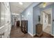 Hallway with hardwood floors, base moulding, display cabinet and doors to other areas at 2149 Hontoon Rd, Deland, FL 32720