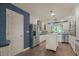 Bright kitchen with stainless steel appliances, white cabinetry, tile backsplash, and wood floors at 2149 Hontoon Rd, Deland, FL 32720