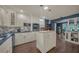 Bright and open kitchen with stainless appliances, tiled backsplash, and an island, seamlessly flows into the dining area at 2149 Hontoon Rd, Deland, FL 32720
