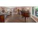 Spacious living room featuring a grand piano, built-in shelving, and lots of natural light at 2149 Hontoon Rd, Deland, FL 32720