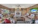 Spacious living room with a stone fireplace, built-in shelves, and comfortable seating arrangement at 2149 Hontoon Rd, Deland, FL 32720