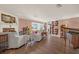 Bright living room showcasing hardwood floors, a cozy fireplace, and elegant white sofas at 2149 Hontoon Rd, Deland, FL 32720