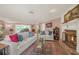 Relaxing living room features a fireplace, comfortable seating, and a decorative rug at 2149 Hontoon Rd, Deland, FL 32720