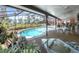 Screened pool with outdoor dining and water view at 2149 Hontoon Rd, Deland, FL 32720
