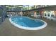 Beautiful kidney-shaped pool with a white stone border, surrounded by patio furniture at 2149 Hontoon Rd, Deland, FL 32720