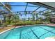 Inviting screened-in pool area with views of the lush yard, waterfront and landscape for relaxed outdoor living at 2149 Hontoon Rd, Deland, FL 32720