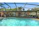 Back of house view of screened pool with patio and fireplace at 2149 Hontoon Rd, Deland, FL 32720