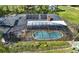Aerial shot of screened in pool area with solar panels on roof, surrounded by lush greenery and manicured landscape at 2149 Hontoon Rd, Deland, FL 32720