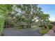 Circular driveway surrounded by mature trees and manicured lawn leading to home at 2149 Hontoon Rd, Deland, FL 32720