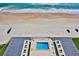 Stunning aerial view of a beachfront pool, white sand, and turquoise ocean at 2200 N Atlantic Ave # 1201, Daytona Beach, FL 32118