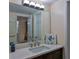 Bright vanity area with quartz counters, neutral paint, and decorative art at 2200 N Atlantic Ave # 1201, Daytona Beach, FL 32118