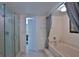 Well-lit bathroom features a luxurious shower and soaking tub with tile surround at 2200 N Atlantic Ave # 1201, Daytona Beach, FL 32118