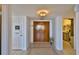 Inviting entryway features tiled floors, wood doors, vintage tv intercom, and decorative lighting at 2200 N Atlantic Ave # 1201, Daytona Beach, FL 32118