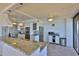 Modern kitchen with white cabinetry, granite countertops, stainless appliances, and ocean views at 2200 N Atlantic Ave # 1201, Daytona Beach, FL 32118