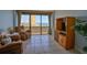 Comfortable living room boasts ocean views, balcony access, and a wooden entertainment center at 2200 N Atlantic Ave # 1201, Daytona Beach, FL 32118