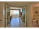 Bright living room with sliding doors to balcony overlooking the ocean and an adjacent powder room at 2200 N Atlantic Ave # 1201, Daytona Beach, FL 32118