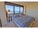 Bedroom features a large bed, lamps, and ocean views from floor-to-ceiling windows at 2200 N Atlantic Ave # 1201, Daytona Beach, FL 32118
