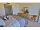 Relaxing bedroom featuring tiled floors, neutral decor, and a dresser with mirror at 2200 N Atlantic Ave # 1201, Daytona Beach, FL 32118