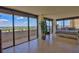 Large bedroom features tiled floors, balcony access, and views of the intracoastal waterway at 2200 N Atlantic Ave # 1201, Daytona Beach, FL 32118