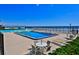 Exterior view of community pool and furniture overlooking sandy beach and the ocean at 2200 N Atlantic Ave # 1201, Daytona Beach, FL 32118
