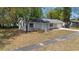 Aerial view of home featuring neutral exterior, landscaping, gray roof and driveway at 2240 Conway Dr, Deltona, FL 32738