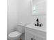 Modern half bathroom featuring a sleek vanity with matte black fixtures and a low-flow toilet at 2240 Conway Dr, Deltona, FL 32738
