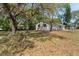 Charming exterior of a single-story home with a well-maintained lawn and mature trees at 2240 Conway Dr, Deltona, FL 32738