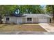 Single-story home features a manicured lawn, attached two-car garage and neutral exterior at 2240 Conway Dr, Deltona, FL 32738
