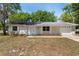 Charming single-story home features a manicured lawn, attached two-car garage and neutral color scheme at 2240 Conway Dr, Deltona, FL 32738