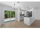 Eat in kitchen with white cabinets, hardwood floors, stainless steel appliances and access to backyard at 2240 Conway Dr, Deltona, FL 32738