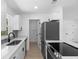 Well-lit kitchen showcasing granite countertops, stainless appliances, and ample cabinet space at 2240 Conway Dr, Deltona, FL 32738