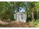 Outdoor storage shed nestled among lush ferns and bamboo at 2240 Conway Dr, Deltona, FL 32738