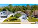 Aerial view showcases this well-maintained home, featuring a lush lawn and a driveway at 2274 Stonehedge Loop, Kissimmee, FL 34743