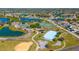 Aerial shot of community park with playgrounds, sports courts, walking trails, and a small picturesque lake at 2274 Stonehedge Loop, Kissimmee, FL 34743