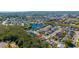 An aerial view shows the property located near a serene lake and lush greenery at 2274 Stonehedge Loop, Kissimmee, FL 34743