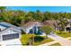 Aerial view of a well-maintained home featuring a landscaped yard and driveway at 2274 Stonehedge Loop, Kissimmee, FL 34743