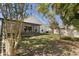 A beautiful backyard featuring a screened-in porch and nice landscaping at 2274 Stonehedge Loop, Kissimmee, FL 34743