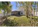 A serene backyard features an outdoor seating area and mature landscaping at 2274 Stonehedge Loop, Kissimmee, FL 34743