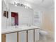 Bright bathroom with a double sink vanity, large mirror, and a combined bathtub and shower at 2274 Stonehedge Loop, Kissimmee, FL 34743